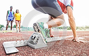 Runner using starting block to start his run on race track - Young athlete starting his sprint on running track -  Healthy