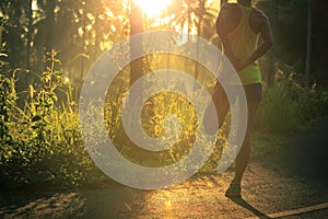 Runner warming up before running at morning forest trail