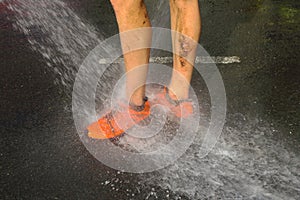 Runner washing mud from legs