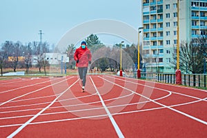 Runner wearing medical mask, Coronavirus pandemic Covid-19 in Europe. Sport, Active life in quarantine surgical sterilizing face