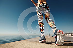 Runner woman feet running on road closeup on shoe.