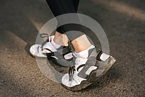 Runner woman feet running on road closeup on shoe. Sports healthy lifestyle concept