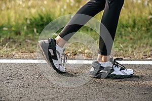 Runner woman feet running on road closeup on shoe. Sports healthy lifestyle concept