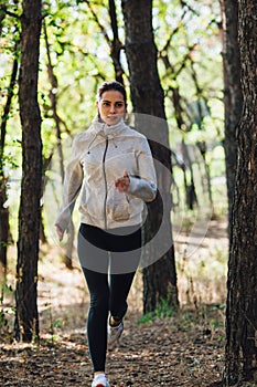 Runner woman jogging in autumn park