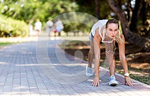 Runner woman jogging in summer fitness workout. Running, sport, healthy active lifestyle concept. At start.