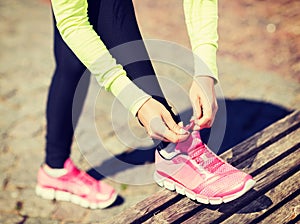 Runner woman lacing trainers shoes