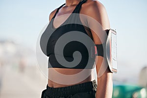 Runner woman, phone and arm in closeup for wearable tech, fitness and tracking info for exercise goals. Girl, smartphone