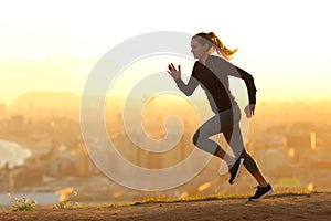 Runner woman running in the outskirts of the city