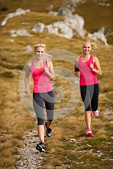 Runner - woman runs cros country on a path in early autumn