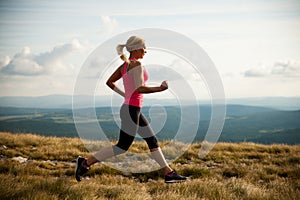 Runner - woman runs cros country on a path in early autumn