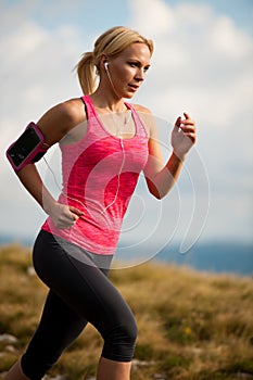 Runner - woman runs cros country on a path in early autumn