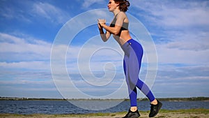 Runner woman stretching legs with lunge hamstring stretch exercise leg stretches. Fitness female athlete relaxing on