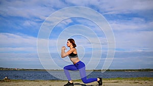 Runner woman stretching legs with lunge hamstring stretch exercise leg stretches. Fitness female athlete relaxing on