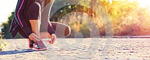 Runner Woman Tying Her Shoelaces While Jogging