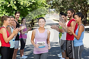 Runners applauding a racer in the park