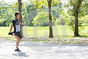 Runners Asian man is warming the body before running