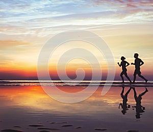 Runners on the beach, silhouette of people jogging at sunset, healthy lifestyle