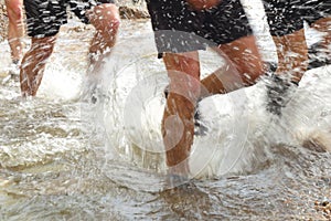 Runners crossing the river