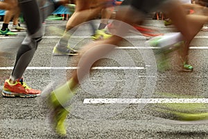 Runners feet on the road in blur motion