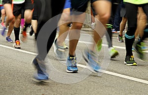 Runners feet on the road in blur motion