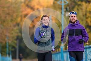 Runners fitness couple running in the city park