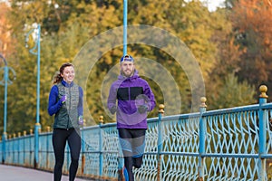 Runners fitness couple running in the city park