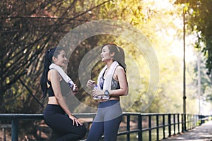 Runners fitness couple running in the city park, Two women exercising by jogging