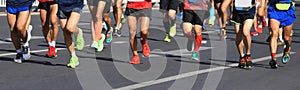 runners legs running on city road photo