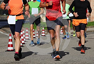 runners during the marathon on the city streets run in sneakers