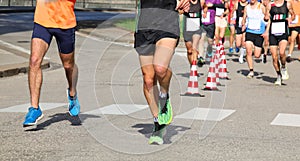 runners during the marathon on the city streets run in sneakers