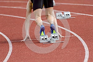 Runners preparing for race at starting blocks