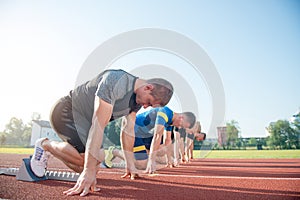 Runners preparing for race at starting blocks