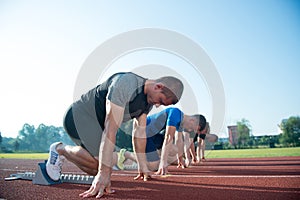 Runners preparing for race at starting blocks