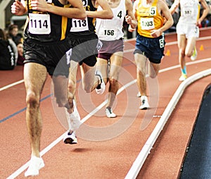 Runners racing in a straight line on an indoor track