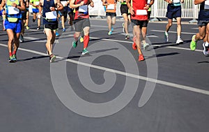 Runners running on city road photo