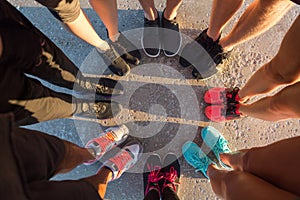 Runners standing in a huddle with their feet together