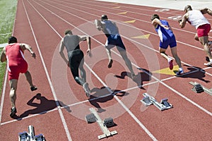 Runners Starting Race On Racetrack