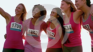 Runners supporting breast cancer marathon and taking selfies