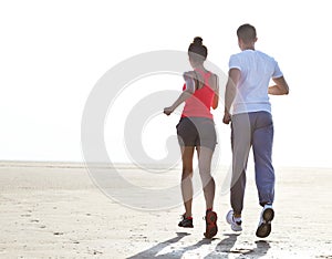 Runners training outdoors working out in nature against blue sky