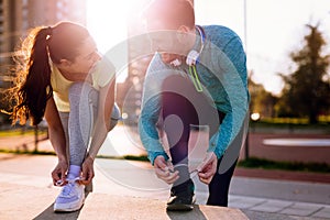 Runners tying running shoes and getting ready to run