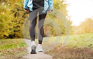 Running along a park path, healthcare and problem concept - close-up of an unhappy person suffering from pain in the leg or knee
