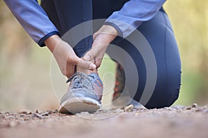 Running, ankle pain and injury with shoes of black woman on nature trail for training, jogging and endurance. Sprain