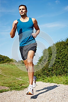 Running, athlete and man, fitness and nature for sports, energy and practice, exercise and health outdoor. Workout