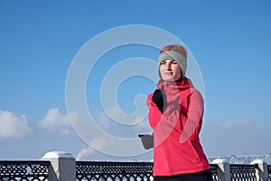 Running athlete woman sprinting during winter training outside in cold snow weather. Close up showing speed and movement
