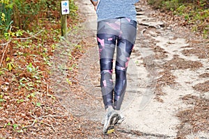Running athlete woman walking exercise healthy and lifestyle concept in wooden pathway forest park