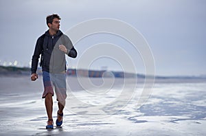 Running, beach and man with vacation, health and exercise with nature, energy and ocean. Person, runner and guy with fun