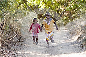 Running Black African Ethnicity Boys Having Fun Smiling and Laughing in Typical African Village Town