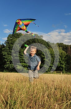 Running boy with flying kite