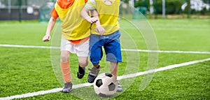 Running boys playing football soccer match