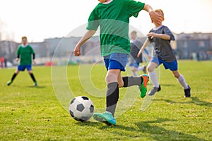 Running Children Football Players. Kids Playing Soccer Match. Football Players Duel on Grass Pitch